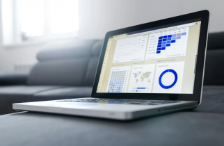 Laptop Displaying Several Business Graphs